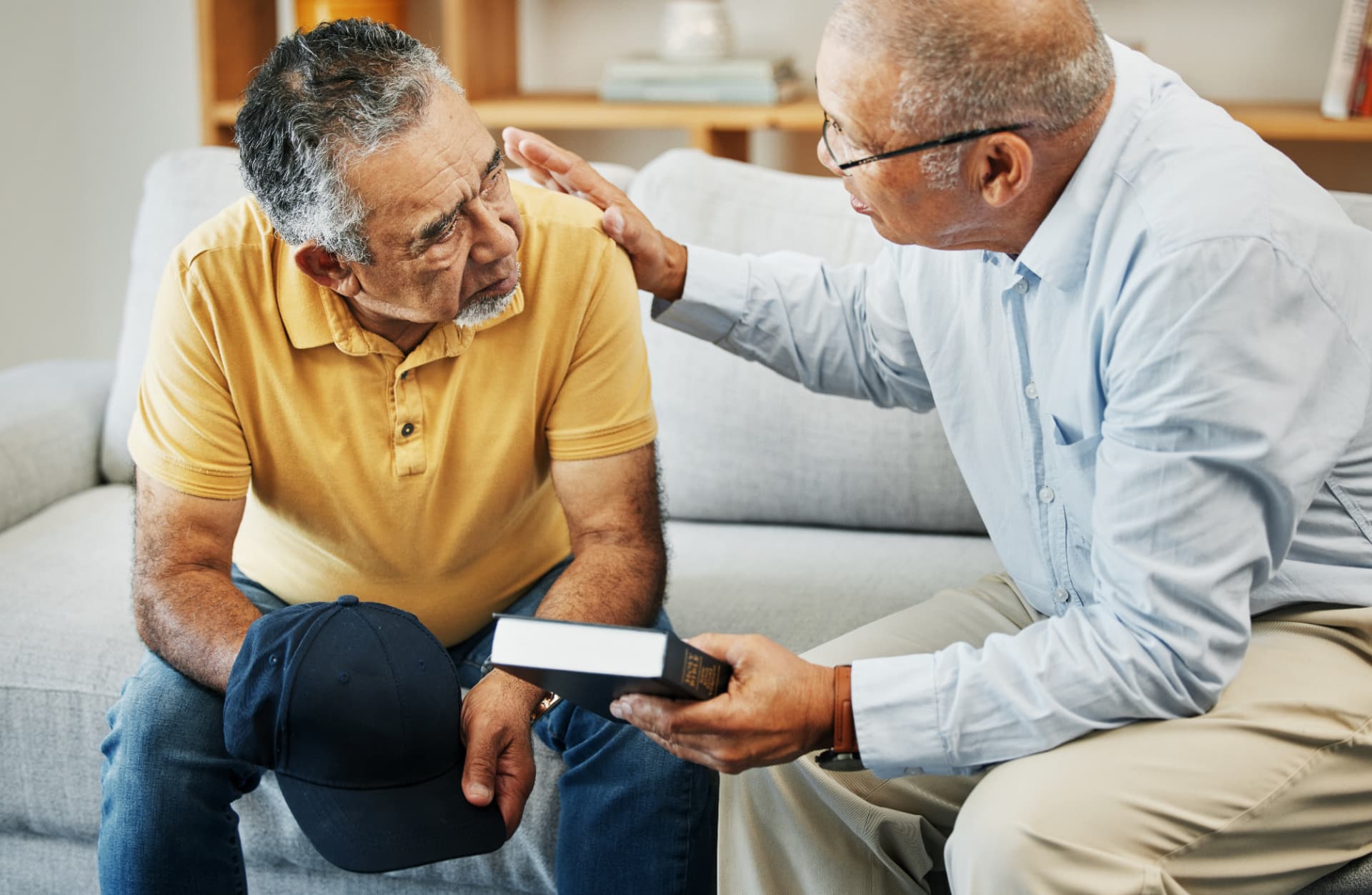 Pastor offering counsel and prayer to a church member